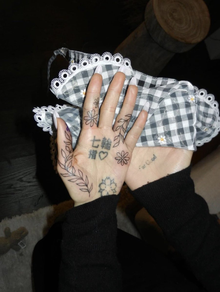 Ariana Grande shares photos of her new hand tattoos.