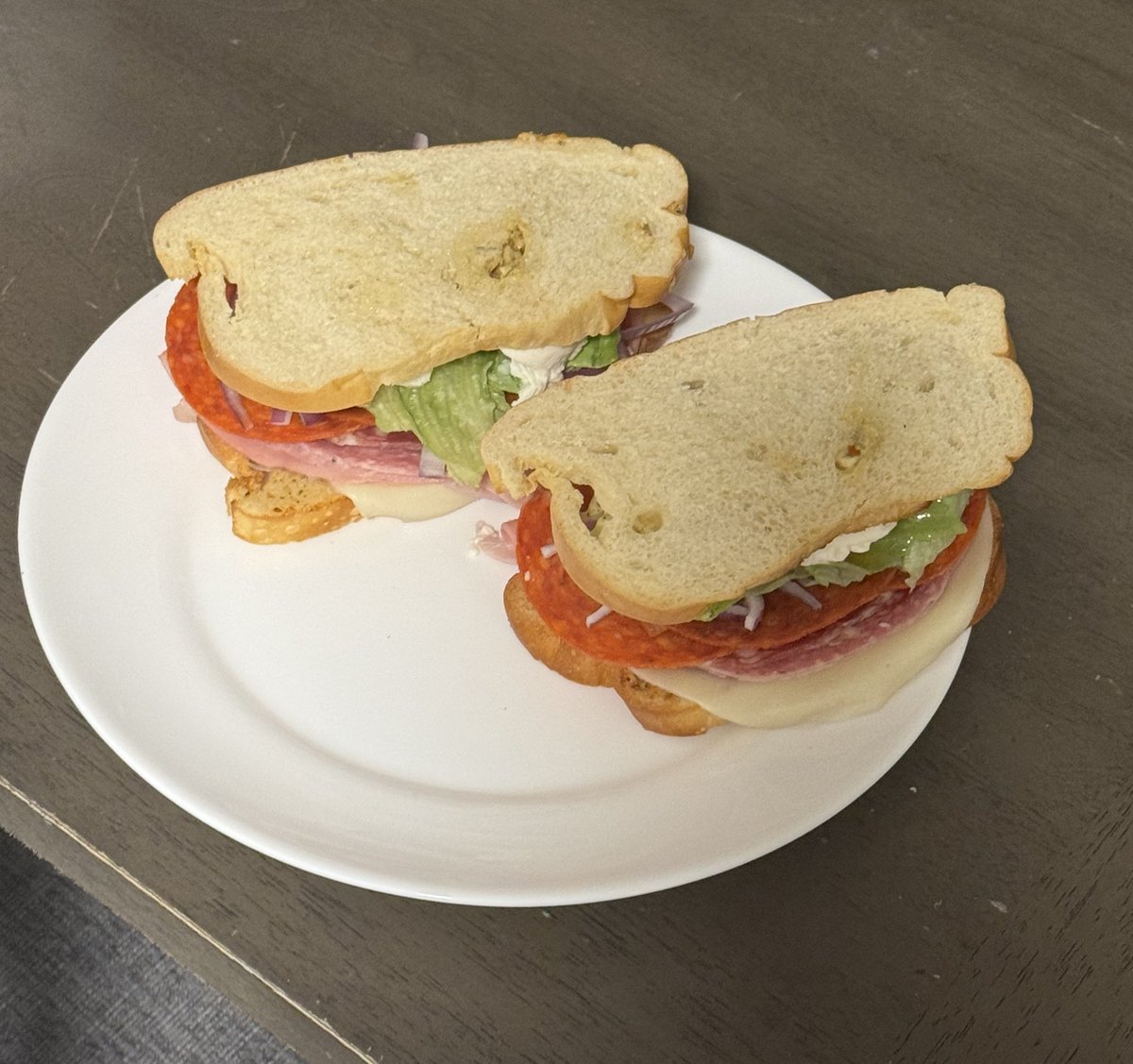 Toasted Italian loaf with garlic butter, oil/vinegar spread, genoa salami, soppressata, mortadella, pepperoni, and ham with provolone and burrata, lettuce, tomato, red onion, cherry peppers.