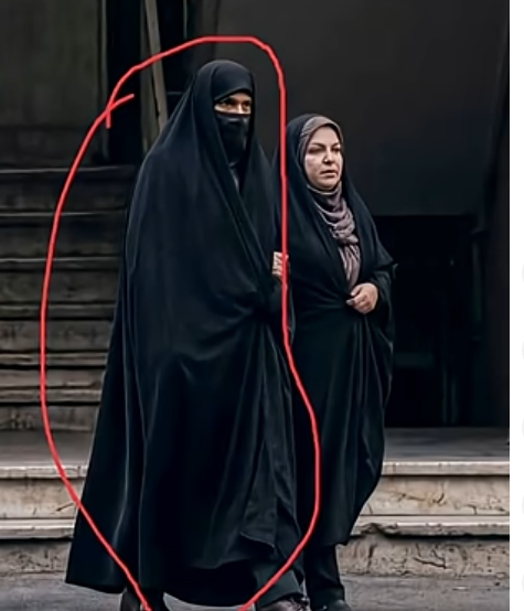 Shima345514's tweet image. An IRGC member hiding under a woman’s hijab to blend in among civilians. This exposes how far the regime goes to control the streets through fear. #EndIRGC #FreeIran‌ @POTUS @IsraeliPM