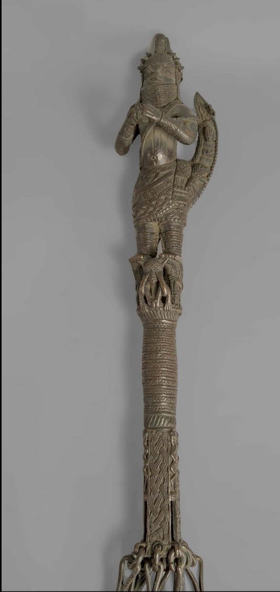 Brass whip held by the Ọba or other members of the royal court, with Igheghan bells beneath each whip, and at the top of the whip stood the Ọba standing on a mythical being. 

-ca.18th century