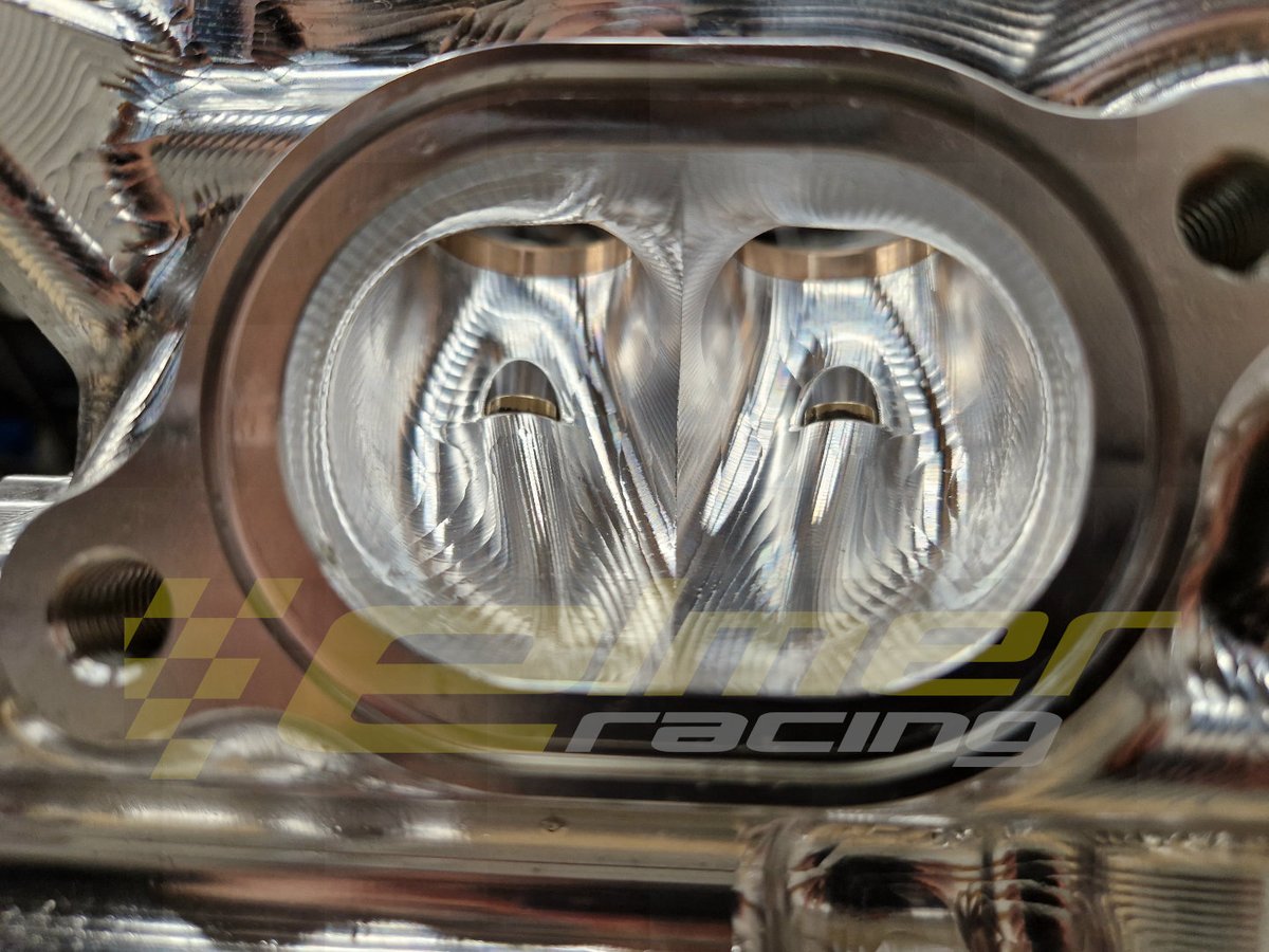ElmerRacing's tweet photo. Close up look at how hard the design is pushed on our 4000hp Hel engine.
Intake and exhaust valve guides are fully integrated into the port design. And the port cross section area fully takes this shape into account.
The exhaust value guides have a shorter external end taper and different internal diameter for the tip to reduce the temperature of the tip. But still needs to be very close to the valve head to get good heat conduction and valve cooling.
Intake side is fully contoured behind the valve guide hump to reduce turbulence.
At full power both the intake and exhaust flow is mach limited during the entire valve open period. Shapes and maintaining port cross section really matter to help reduce shock waves and port flow losses close to the valve.