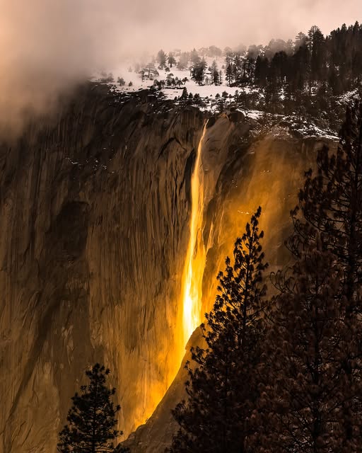 Horsetail Falls unique beauty is amplified by its seasonal transformation during February. As the setting sun hits the waterfall at the right angle, the water appears to glow with a vibrant orange and red hue, resembling a flowing curtain of fire.  Photo Courtesy of Dan Kurtzman.