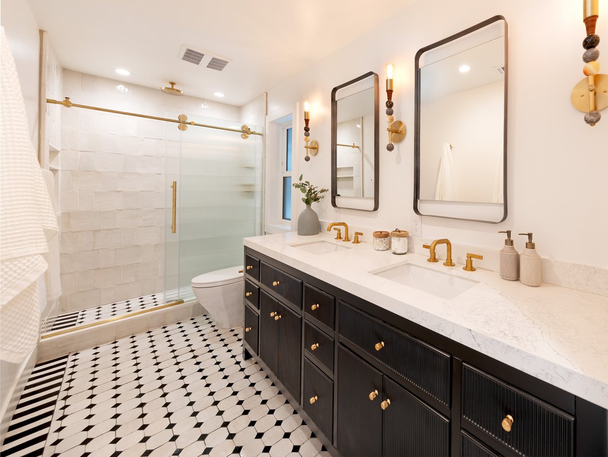 In the Goodland Bungalow, the bathroom balances warmth and contrast, pairing gold fixtures and a marble countertop with crisp black cabinetry and a bold, black-and-white patterned floor.
.
INSPIRE | CREATE | IMPACT
