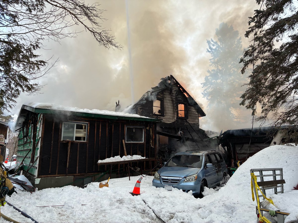 OttFire's tweet photo. Firefighters battled a fully engulfed bungalow yesterday afternoon in the 5900 block of Prince of Wales Drive.

At approximately 15:07, the Ottawa Fire Services Communications Division received multiple 9-1-1 calls reporting that a single-family bungalow was completely on fire. The initial caller, a neighbour, reported that “the whole house is on fire,” which was confirmed by subsequent callers.

Firefighters arrived on scene within three minutes of dispatch and confirmed heavy fire conditions, with flames venting through the roof. Two occupants had safely evacuated prior to our arrival and were assessed by our partners at @OttawaParamedic.

Crews immediately encountered significant hazards. An arcing powerline had burned through and fallen at the front of the home, creating a dangerous condition. During suppression efforts, a second live hydro line also came down, adding to the risks on scene.

Firefighters advanced multiple hose lines around the structure to conduct a defensive attack. As the area does not have fire hydrants, tanker trucks were used to shuttle water from a nearby source to sustain firefighting operations.

Due to the extensive fire involvement throughout the home, crews were unable to make entry to conduct interior searches. The occupants confirmed they were the only two people inside at the time of the fire.

An aerial ladder was deployed to attack the fire from above. The fire was declared under control at 18:10.

An excavator was later brought in to assist with overhaul operations, allowing Firefighters to access and extinguish remaining hot spots and prevent flare-ups.

An @OttFire Investigator was dispatched to determine the cause and origin of the fire. #OttNews