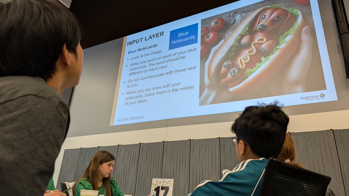 argonne's tweet photo. How would you describe this image?
Students at #IGED learn the fundamentals of how large language models process information.
The thought experiment had learners move one-word descriptors from input to hidden to output layers, seeing how meaning changed along the way. https://t.co/Q5MHDzqnYv