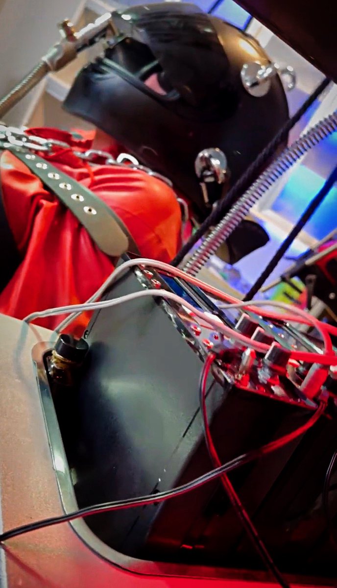 Modified racing helmet with anesthesia mask inside, connected to breathing assist as the E-Stim is turned up and the warmup intensifies. Lady Bridget Ballard and Lady Sindy Ballard cranking the intensity with a slave of over 15 years. Thousands of hours together and each scene