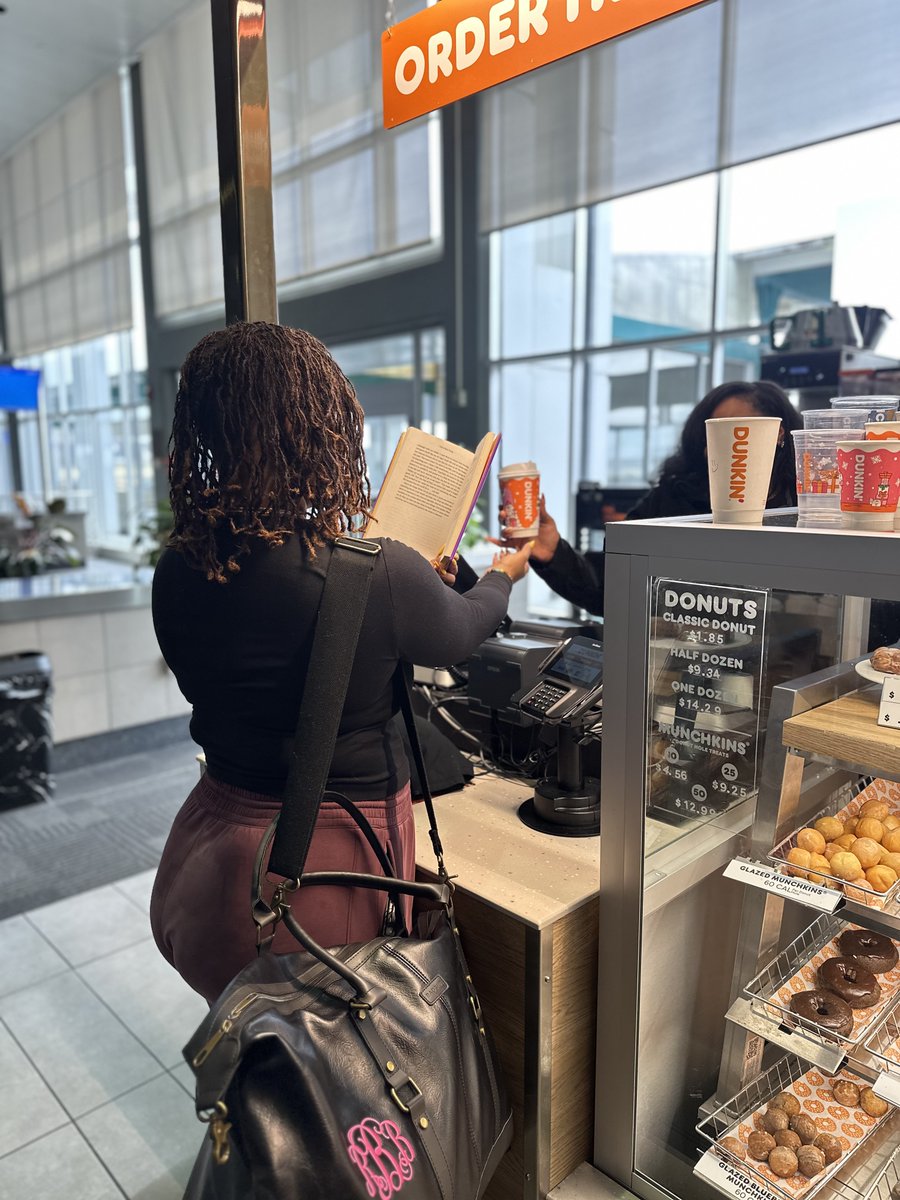 JacksonAirports's tweet photo. She’s booked. 📚✈️
Robyn, a proud Jacksonian, grabbed her favorite read, a sweet wake-me-up from Dunkin’, and took literacy to new heights at JAN.
We're bridging literacy in flight — because every journey should take you somewhere great.
#ReadAcrossAmerica #FlyJAN #BookedAtJAN https://t.co/N7YWefQBkP