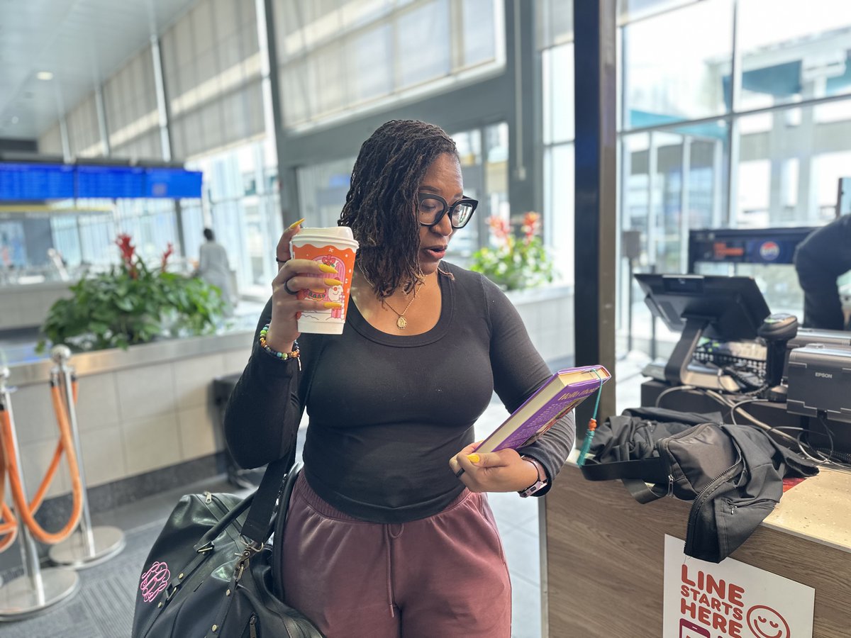 JacksonAirports's tweet photo. She’s booked. 📚✈️
Robyn, a proud Jacksonian, grabbed her favorite read, a sweet wake-me-up from Dunkin’, and took literacy to new heights at JAN.
We're bridging literacy in flight — because every journey should take you somewhere great.
#ReadAcrossAmerica #FlyJAN #BookedAtJAN https://t.co/N7YWefQBkP