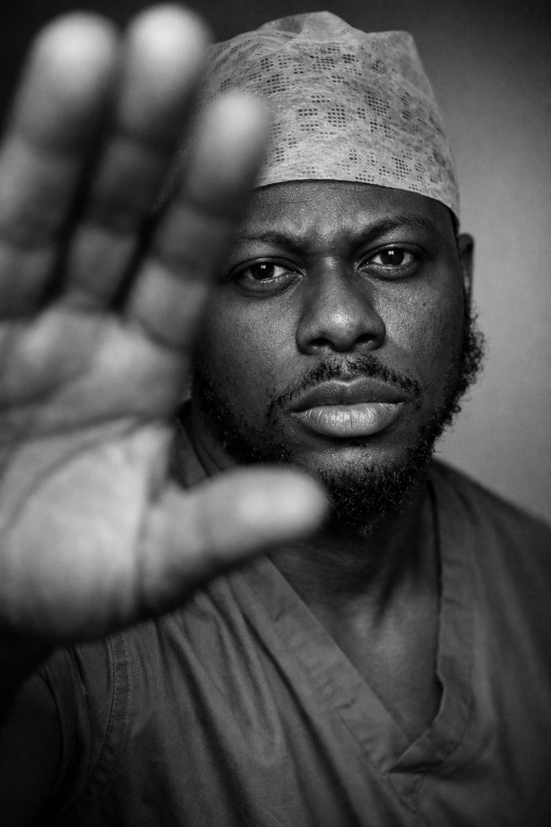 osemagnum's tweet photo. Generate a hot picture of yourself.  Create and upload your fire picture,  let's feed our eyes❤️

Upload a clear picture of yourself and add this prompt!

Using the uploaded facial details- Generate Ultra-realistic cinematic fashion portrait, studio photography. Subject facing the camera with intense, controlled eye contact. Facial expression is serious, calm, and focused, slightly confrontational, no smile, relaxed mouth, steady gaze conveying confidence and presence. One hand raised very close to the lens, palm partially blocking the frame, hand oversized and out of focus in the foreground, creating strong depth separation. Face sharply in focus behind the hand. Tight close-up framing, shallow depth of field. Soft directional studio lighting from one side, subtle sculpted shadows, clean minimal studio background. High-contrast black and white color grading with rich midtones and fine skin texture. Editorial fashion photography style, dramatic, intimate, modern. Full-frame camera look, 85mm lens aesthetic, f/1.8 depth of field, professional studio quality, hyper-realistic, photographic realism, no stylization.