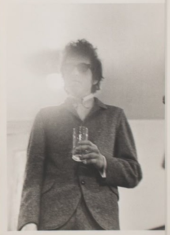 bob dylan holding a glass