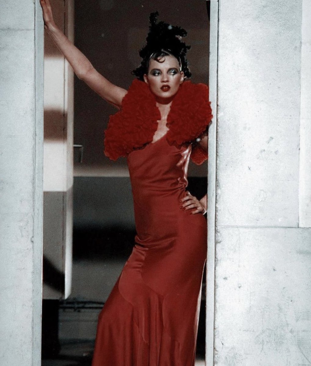 Supermodel Kate Moss kissing Johnny Depp in the middle of her runway walk during John Galliano's Fashion Week