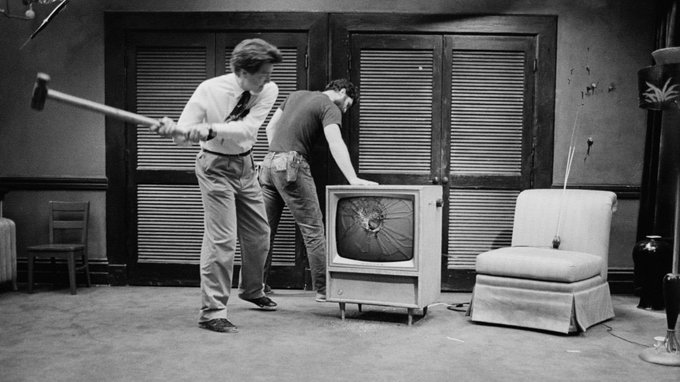 David Lynch smashing the television in preparation for the final scene in Dorothy's apartment on the set of Blue Velvet.