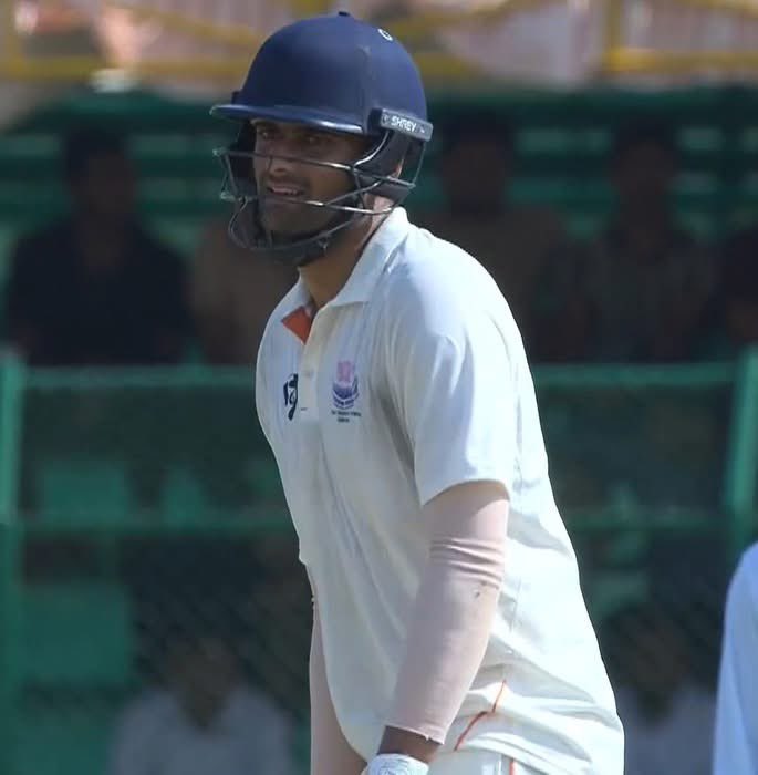 After Khajuria’s sudden injury on match eve, Qamran Iqbal got the call. 11:30 PM flight from Delhi. 1:55 AM in Mumbai. 4-hour wait. 6:15 AM to Hubli. Reached ground 30 mins before toss. Out to bat at 9:30. Didn’t click in 1st innings. Now unbeaten on 55 in the 2nd innings.