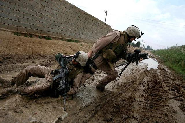 Marine Sgt. Jesse E. Leach drags a comrade shot by a sniper while patrolling in Garma, Iraq, October 31, 2006.