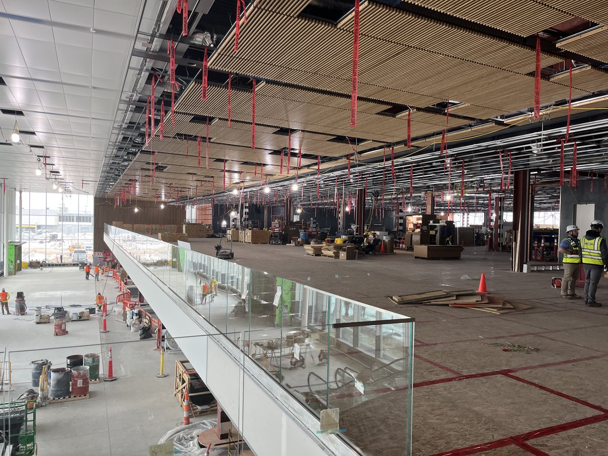 dsmairport's tweet photo. We still have a journey ahead, but it’s exciting to see the finishing touches coming to life. The glass balcony railings, the wood-slatted ceilings ... the details are starting to shine. We can’t wait to welcome you to our new home, DSM!
#FlyingProgress #FridayFinishes https://t.co/6tdlzuF0i4