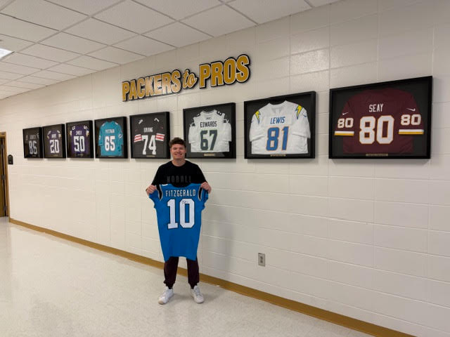 CCPackersFball's tweet photo. We are so proud of @Panthers Kicker, Ryan Fitzgerald and so glad to call him a Packer ! He came by today to deliver his @NFL jersey for the #PackersToPros wall &amp; he spoke to a great group of students for our Partnership for Success Program ! #PackerPointOfPride https://t.co/mg7KPh2RJ9