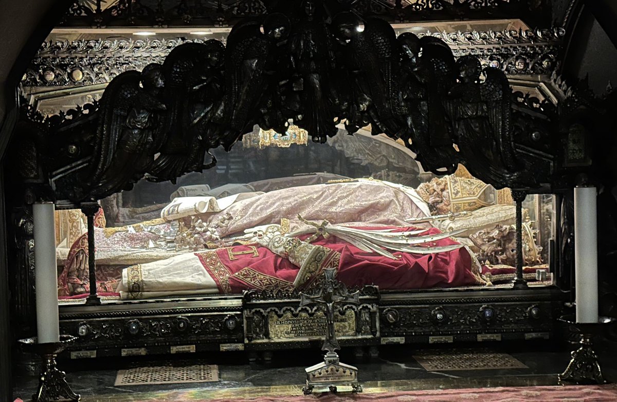JoshuaTCharles's tweet photo. Among the many things that shocked me in the writings and histories of the Church Fathers as a protestant was how many times we protestants resembled the heretics (sometimes even the pagans) of their times in various ways.

One such example is veneration of the relics of the martyrs, the intercession of the saints, and how such things produced miracles.

Multiple ancient writings—including from St. Ambrose himself, as well as St. Augustine—testify to the fact that St. Ambrose had a dream in which the location of the relics of Sts. Protasius and Gervasius (martyrs) were discovered. Once discovered, St. Ambrose displayed their relics in what is today the Basilica of St. Ambrose, and they produced many miracles, including healing a blind man of his blindness (who went on to serve in the basilica for the rest of his life in gratitude for his healing).

I discovered long ago that it was PAGANS who despised the veneration of relics by Christians (though as a protestant, I was always told such veneration was pagan itself). But while reading the “Life of St. Ambrose” (which St. Augustine requested be written by a certain Paulinus), I discovered that the ARIANS also apparently despised it.

As it turns out, when I visited Milan in 2024, I went to the Basilica of St. Ambrose, and saw three sets of relics. I knew one of them—the one in the middle—was St. Ambrose, and was utterly astounded to be in the presence of his bodily remains, given how much he had influenced me toward conversion to the Catholic Faith.

But I also wondered who the two people on either side of him were. A placard nearby told me: Sts. Protasius and Gervasius. I was looking at the very relics of the martyrs that I had read so often about in the writings of various Church Fathers, and other ancient Christian sources. It was as if God was bringing it all full circle. I bowed and venerated their relics, asked for their prayers, and stood in awe of the reality of Christ in them. I took the picture below when I was there.

Now here is the bit showing how the Arians themselves despised this Catholic stuff (and thereby matched many of the attitudes I had received as a protestant):

“Yet, within the palace, a great number of Arians who sided with [Empress] Justina [who persecuted St. Ambrose] ridiculed such grace of God as the Lord Jesus deigned to confer upon His Catholic Church by the merits of its martyrs [through relics/intercession]. And they claimed that the venerable man Ambrose had by means of money prepared men to state falsely that they were troubled by unclean spirits and to say that they were tortured by him just as by the martyrs.”

Paulinus, Life of St. Ambrose (Ch. 5)