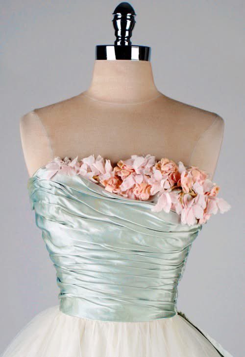 All the colours of tentative spring time, pale and with a wash of blue, the hyper glam of Ceil Chapman deployed in a strapless ballgown. The skirt is a fluff of layers and the bodice wraps the torso tight with a spray of flowers peeping. Sold via <a href="/1stdibs/">1stDibs</a>, 1950s #fashionhistory