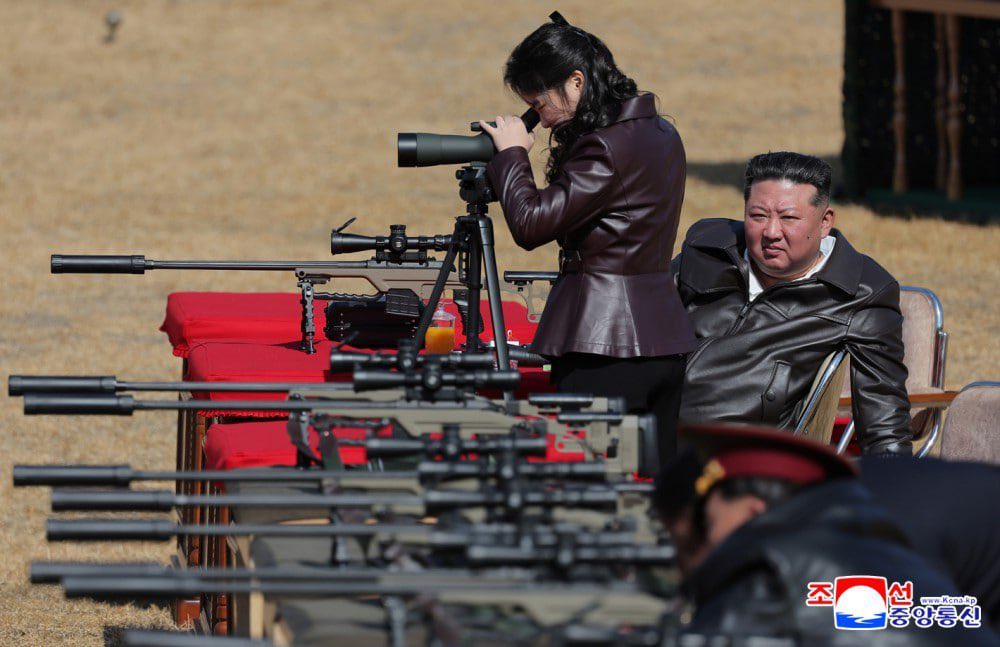 JUST IN: 🇰🇵 Kim Jong Un's daughter spots for him as he tests new sniper rifle.