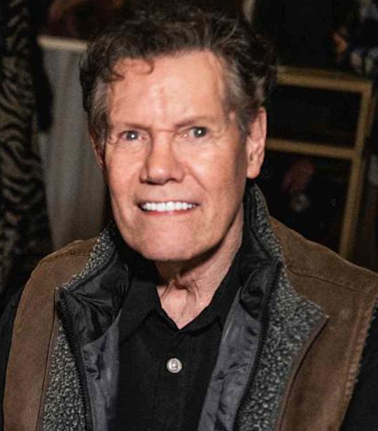 He looks like if Randy Travis had a retarded little brother.