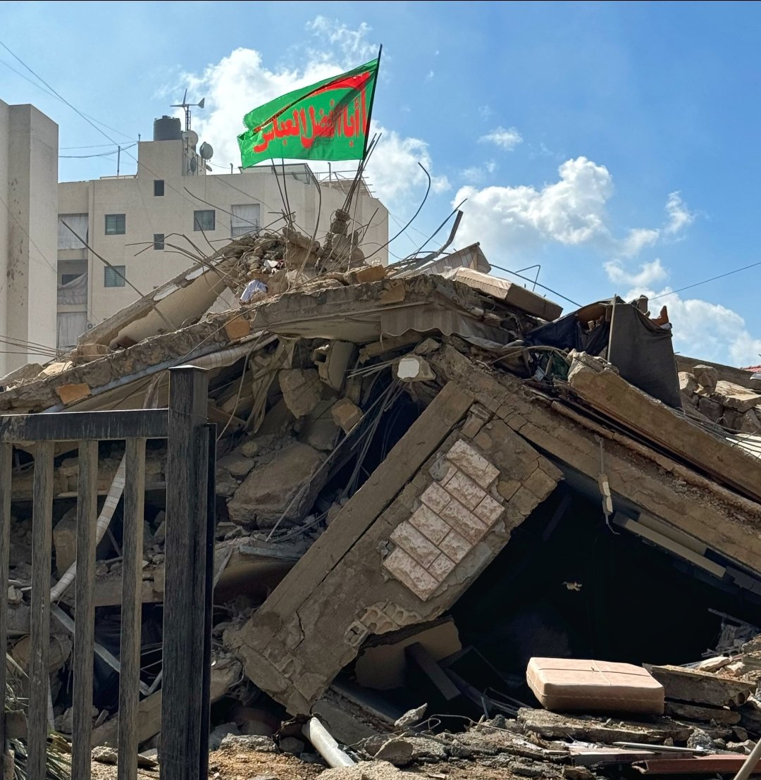 ShabbirAghazada's tweet photo. When Sattar Khan (d. 1914), the Azeri-Iranian revolutionary, was asked to give up and raise the white flag of surrender, he responded:

"I am under the flag of Abu'l-Fadl al-‘Abbas, I will not [surrender] and go under the flag of anyone else!"

"من زیر بیرق ابوالفضلِ عبّاسم،
زیر بیرقِ هیچ‌کسِ دیگر نمیرم!" 

- ستارخان

Abu'l-Fadl al-‘Abbas was the standard-bearer of Imam Husayn and his younger half-brother. In his legend, it is said that he lost both his arms during his furious charge at the battle of Karbala, yet he did not allow the banner of righteousness to fall. He knew death was certain, and he ecstatically sought it. 

For this reason, flags raised in his name have become rallying points for the downtrodden, a source of strength and power for them. As long as his flag flies, the oppressors will be challenged and the movement will live on.

**************
The world needs to understand that Shiʿism is a movement that thrives when faced with certain death. This is the innate power of this ideological tradition: the more it is threatened and oppressed, the stronger it becomes. The core of its philosophy is Karbala, and that is the paradigm it ultimately returns to.

Shiʿism is not concerned with conquering territories, it is not impressed with the stories of Khalid and military expansion that Sunnis grow up with; rather, it is animated by an intense longing for a glorious, sacrificial death in the path of truth, as the family of the Prophet and their tiny band of supporters experienced at Karbala. 

Many may consider this delusional, and perhaps it is, but it is nevertheless a reality that must be understood on the world stage.