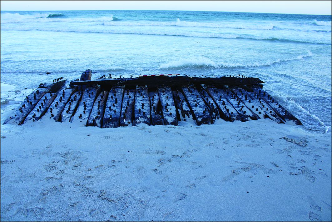 Remains of an 18th-century Royal Navy frigate-turned whaler, exposed due to storminess, unusual wind patterns and sand erosion, linked to climate change. Changes to coastlines will reveal and threaten many similar heritage sites and their political ecologies in the future 1/2