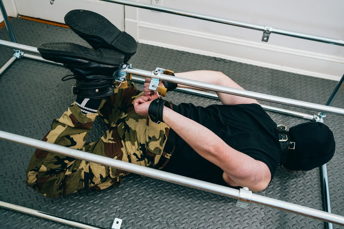 hogtied in leather restraints