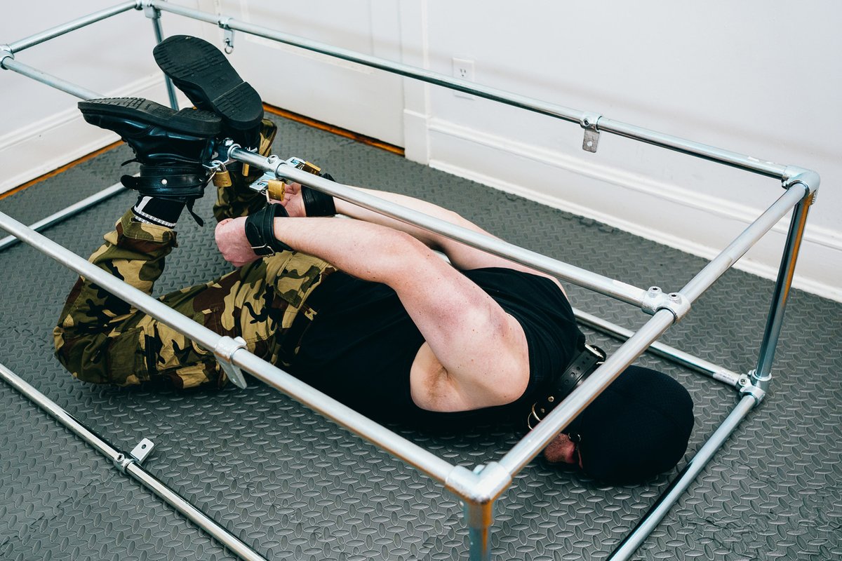 hogtied in leather restraints