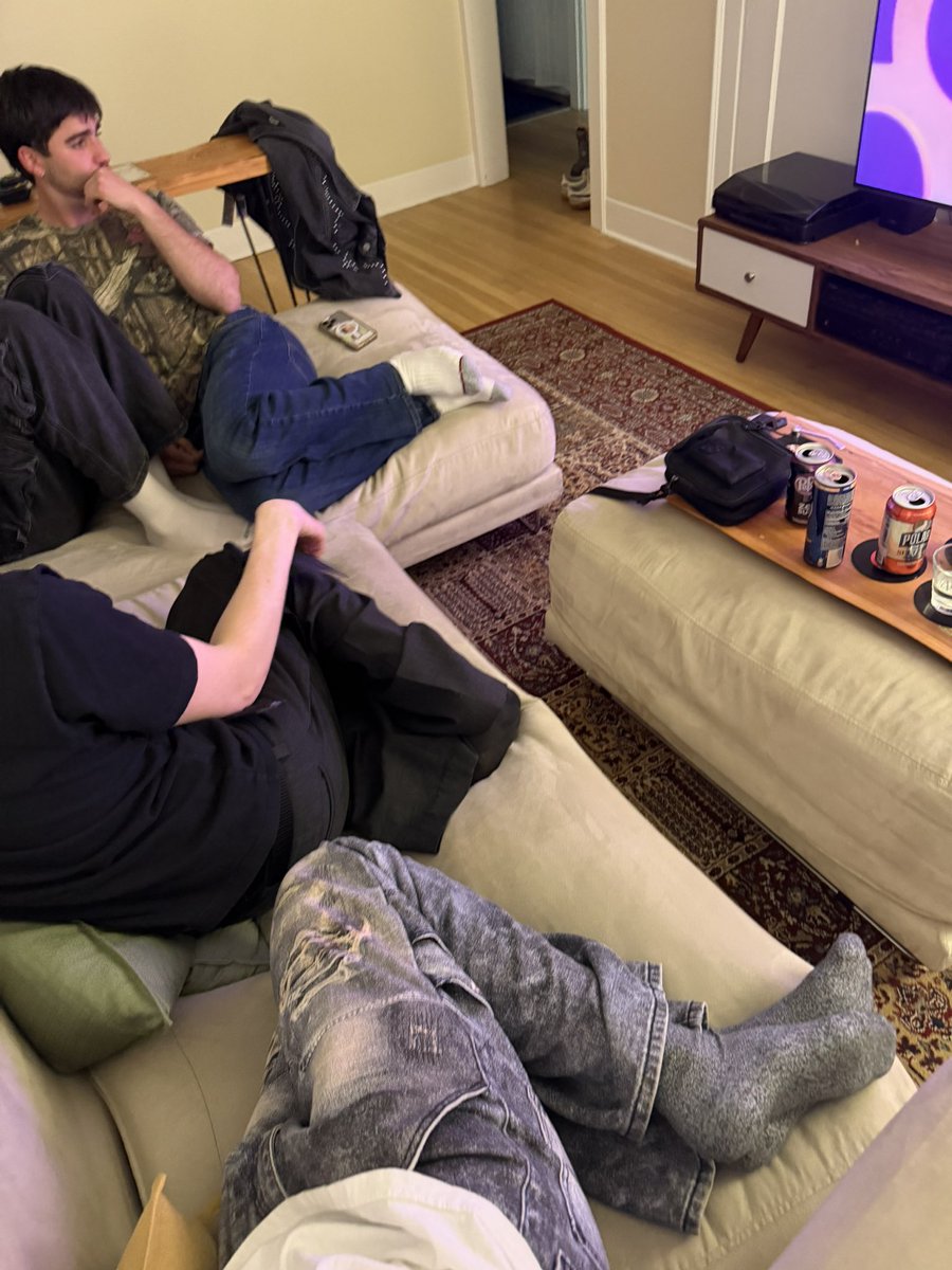 Gay people trying to sit on a couch