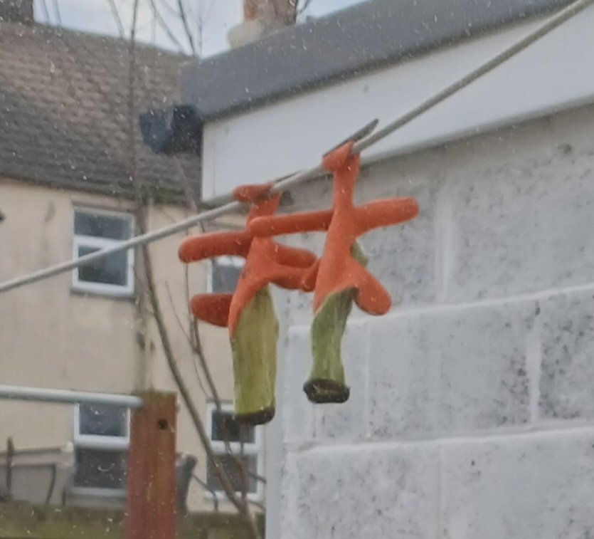 The gloves on the washing line seems to be imitating some sort of character but I can't think which one.