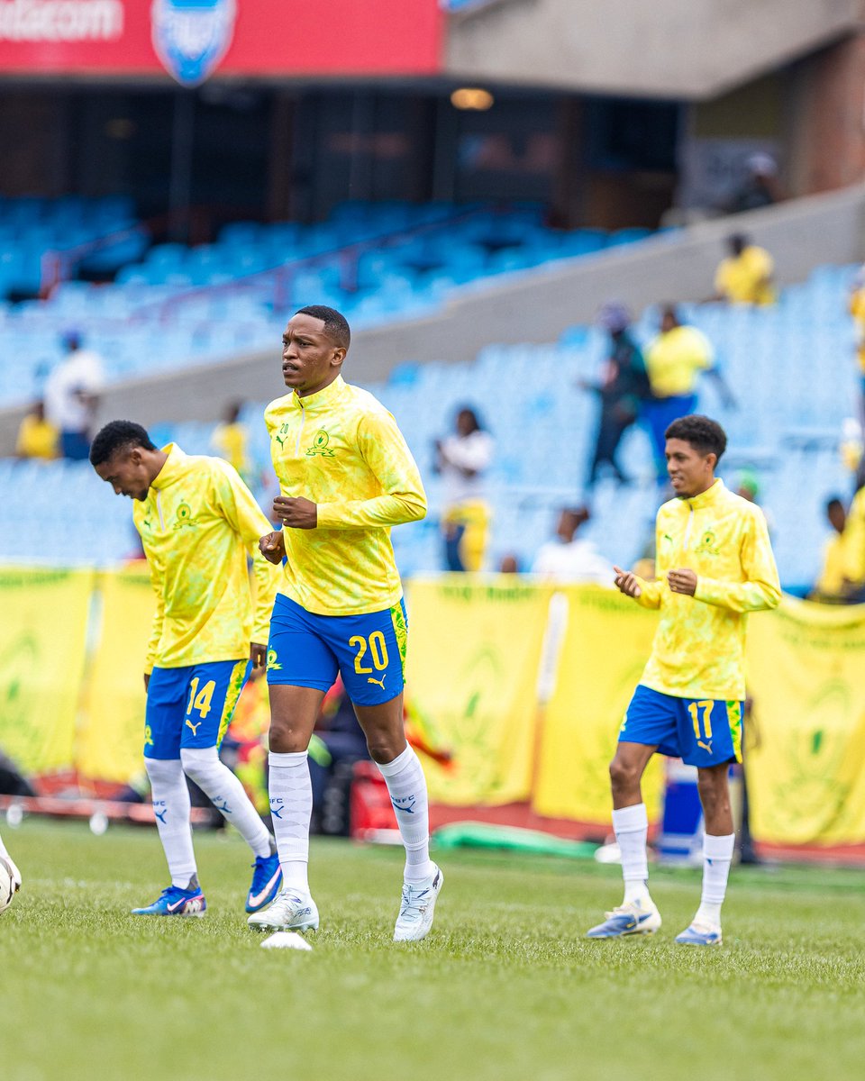 Sundowns players #20, #14 and #17 walking on the field.
