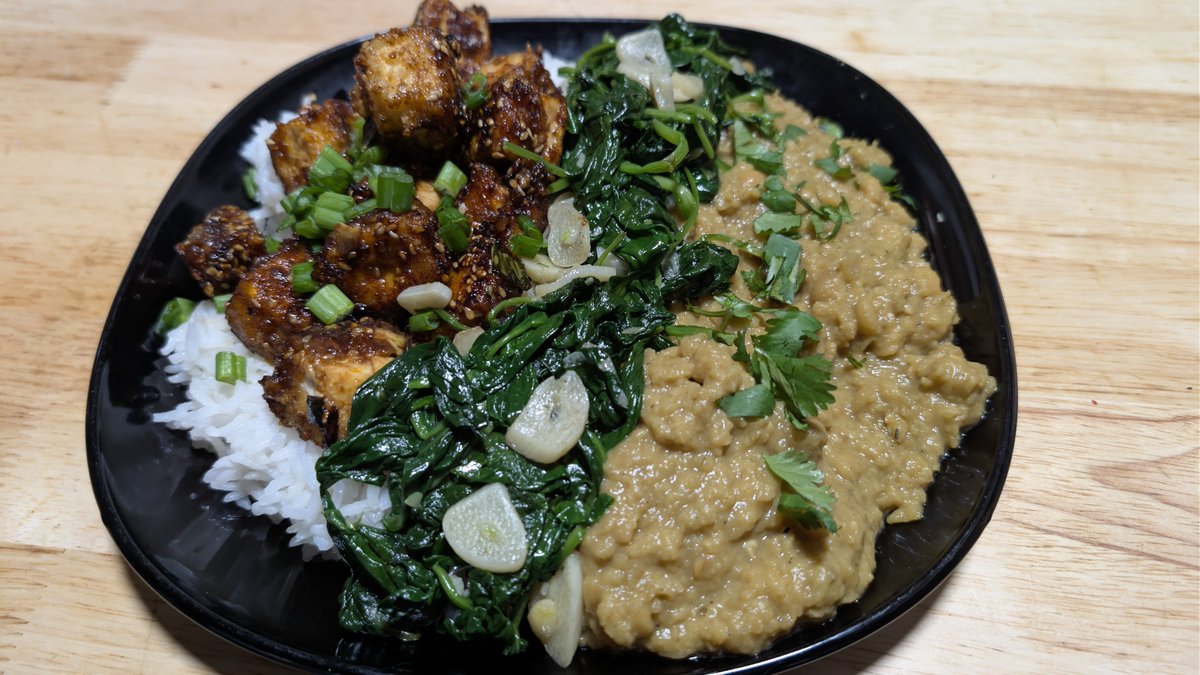 Falconeio's tweet photo. Creamy, yellow split pea dahl topped with fresh cilantro. Delicious sautéed spinach with garlic chips, cooked in roasted sesame seed oil. Sticky sesame seed tofu, with green onion on top of fluffy Japanese rice. https://t.co/6aBL4YarAa