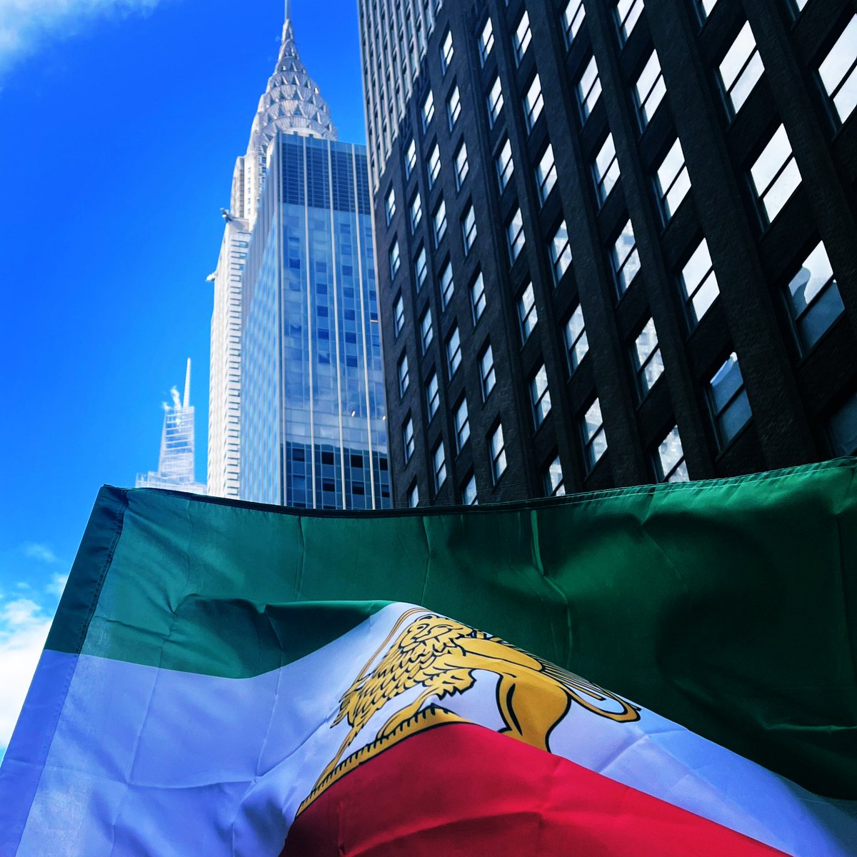 arash_sobhani's tweet photo. Most beautiful shot of the most beautiful building in NY. There I was, surrounded by Iranian demonstrators in NYC, feeling a sudden, desperate need to hug a compatriot who actually gets it. I turned to the guy next to me—who was waving the flag like a pro—and asked for a hug. We embraced. It was a Moment.

Then he looked at me and said, "I’m happy for you... but I’m Italian!"

I was halfway to a mid-protest identity crisis when he added, he added, "But my wife is Iranian, so I’m just as happy!"

Iranian or not, if you love freedom, you are happy today 
#Iran