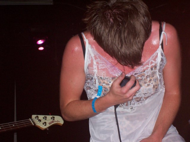 Leopard print bra peaking out from a lace dress