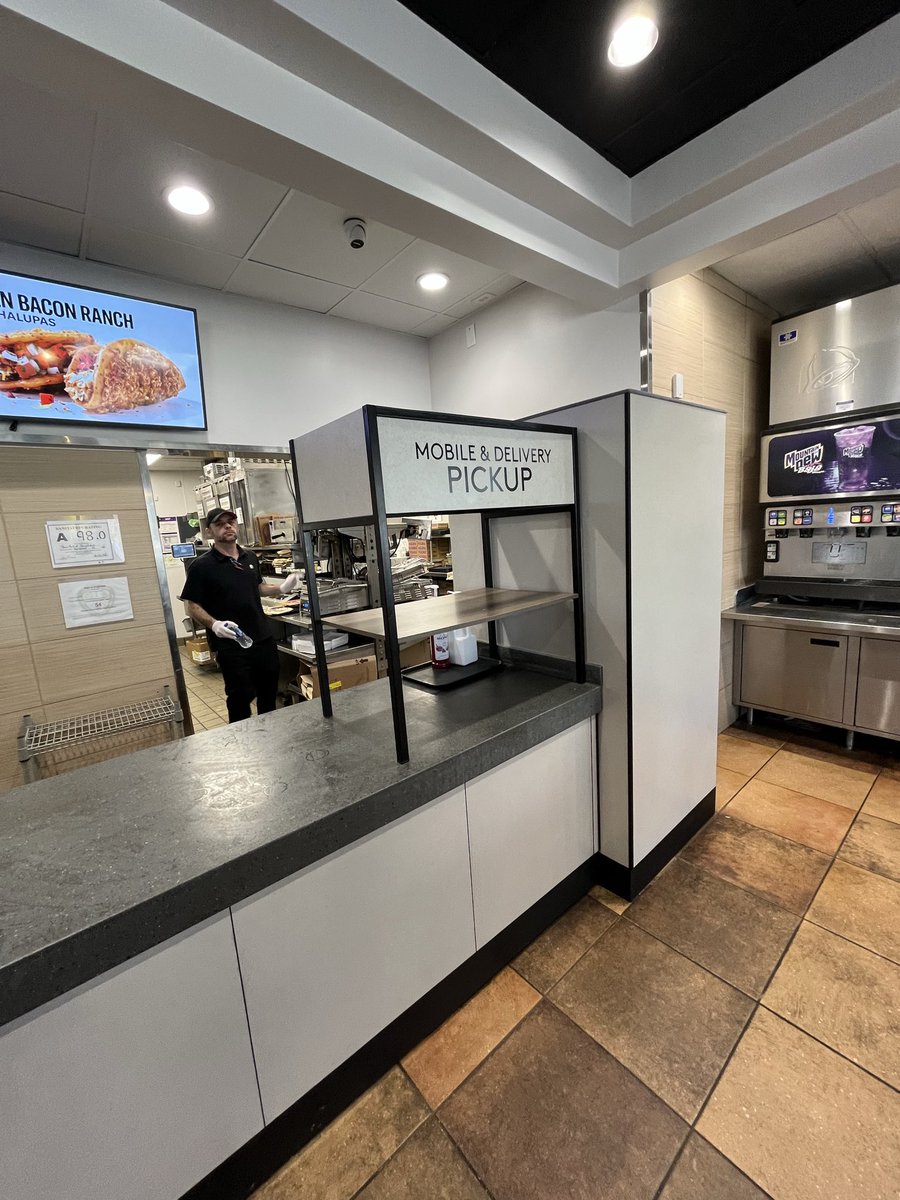 Everything in America is a weird Amazon shell now. This is what’s left of the interior of a Taco Bell, a framed painting denoting a more festive past inside a grayscale soulless box. DAMN