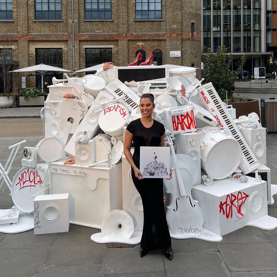 holls21cb's tweet photo. raye on the day of her album release putting a prop of the album cover OUTSIDE the building of her old record label (who said her music won’t do well) will always be so iconic https://t.co/akoPRIb5wq