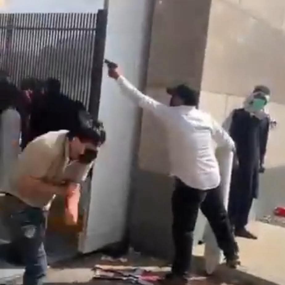 New video angle on the protests at the US Consulate show this man who was with the protestors who pulled out a pistol and fired multiple shots. 

Either someone insane brought a gun to cause chaos, or this is an agent provocateur. He needs to be traced down by authorised asap!