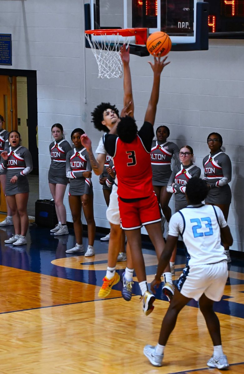 Alton Redbirds vs Belleville East Lancers  - 

Bryce Bennett of the Lancers goes up for a blocked shot on Altons Ryan Howard -