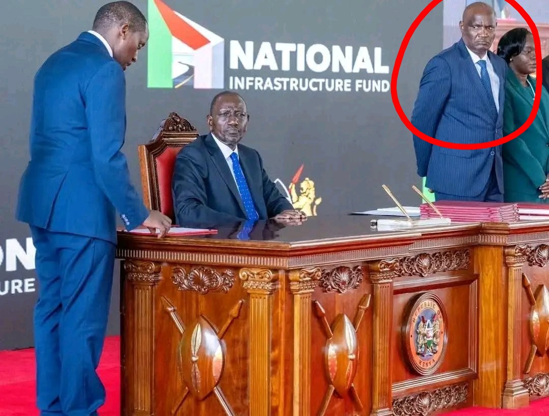 Our flower boy Mbadi wondering how Hussein mastered his signature and is now using it to sign documents that will haunt him in future. 😭😂