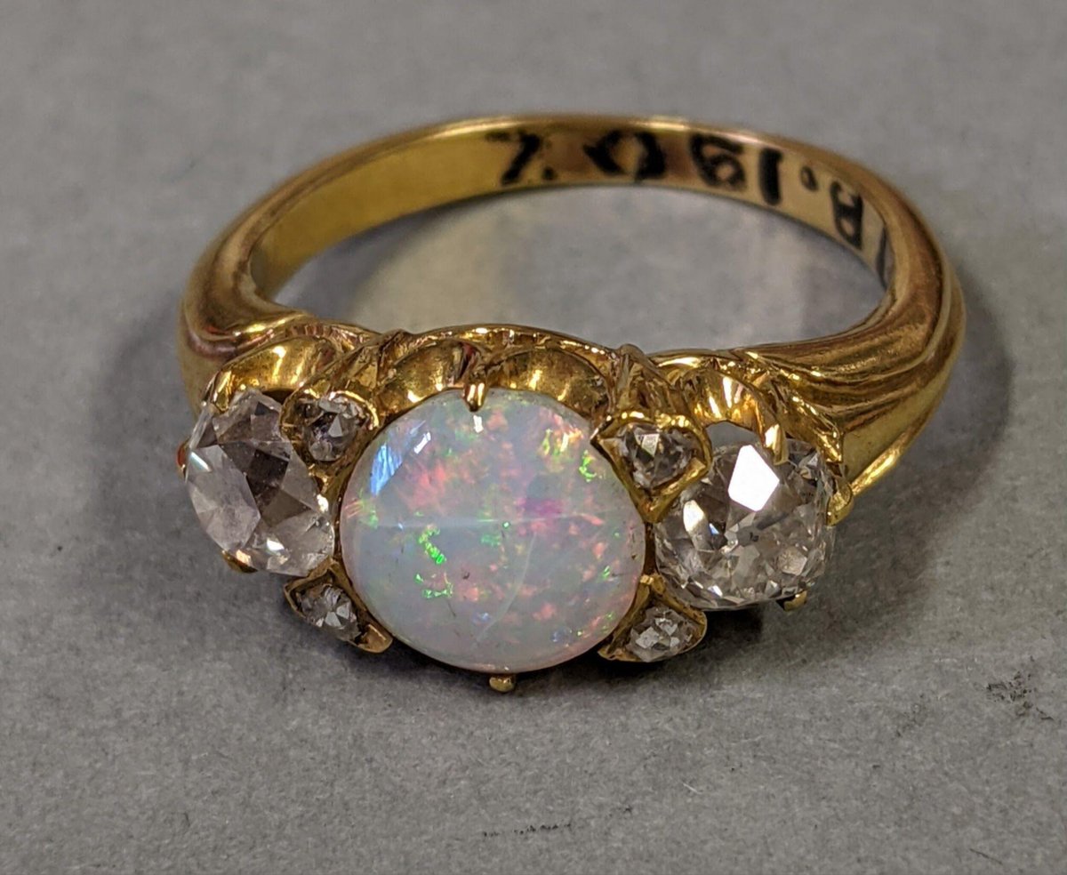 Gold ring set with an opal flanked by two brilliant-cut diamonds held by claws, England, mid 19th century. Victoria &amp; Albert Museum.