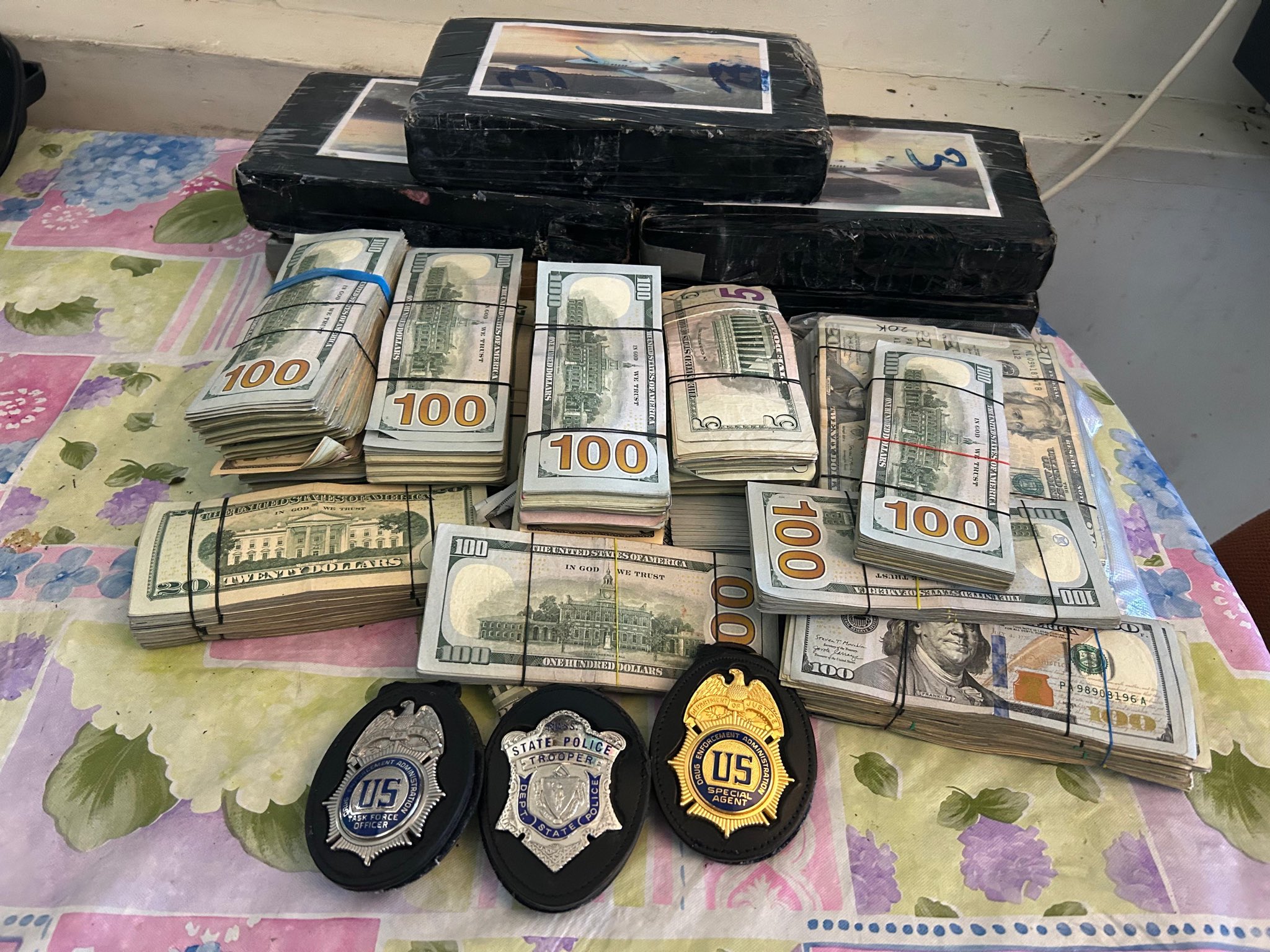 Seized cocaine, cash, and law enforcement badges from East Boston bust