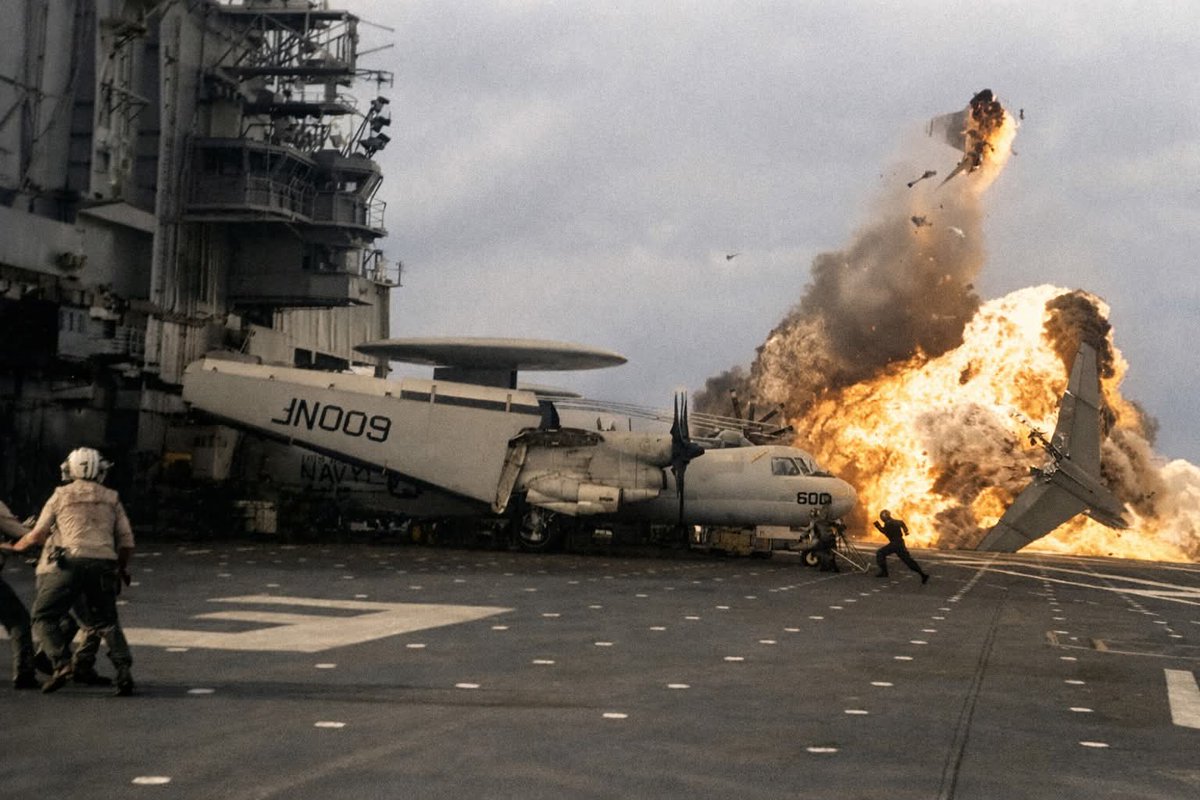 A U.S. Navy LTV A-7E Corsair II aircraft (BuNo 157495) of attack squadron VA-56 Champions bursts into flames after a ramp strike on the aircraft carrier USS Midway (CV-41), on 21 August 1984.