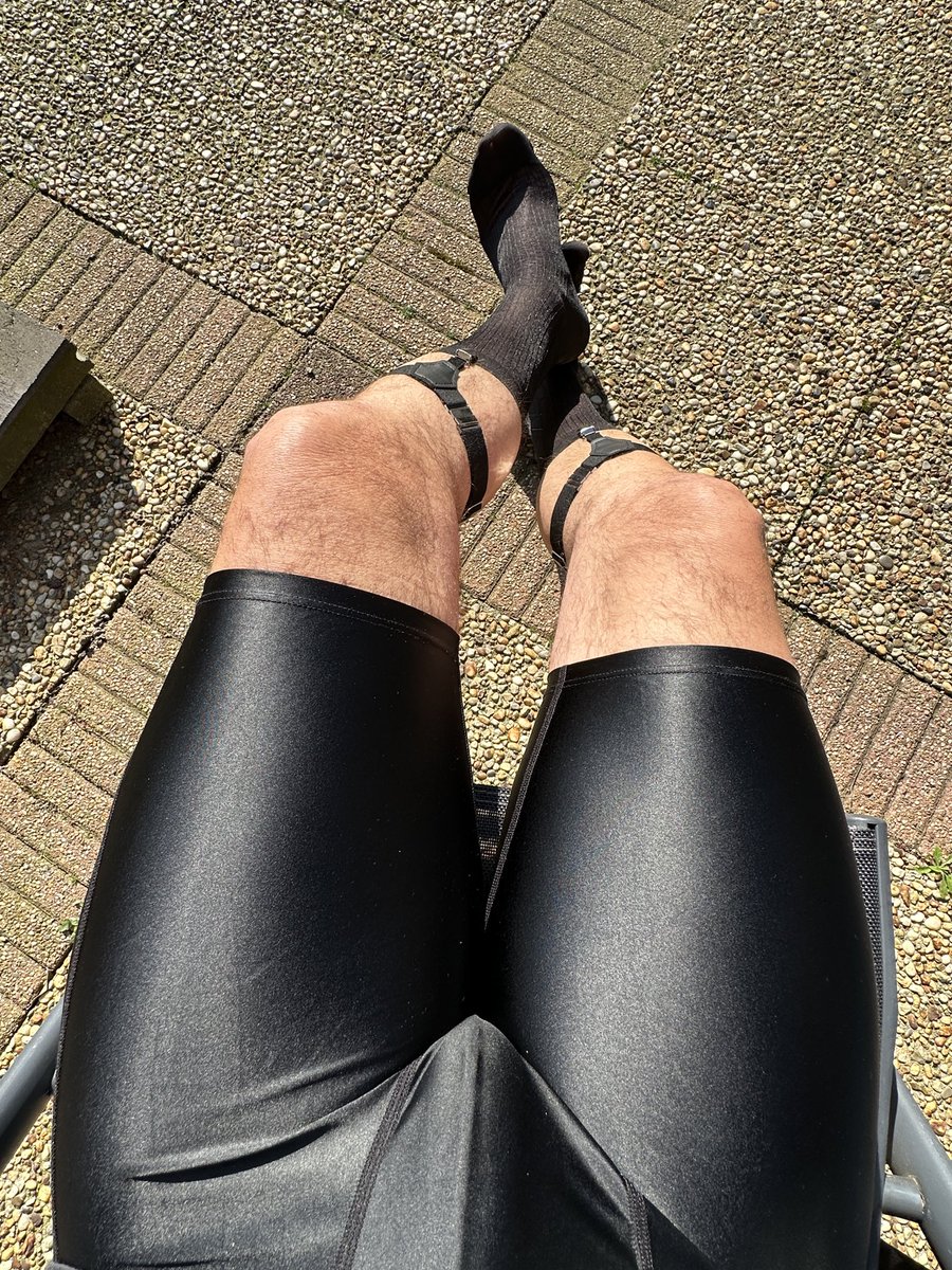 dildobiker's tweet photo. wearing shiny black short tights and silk socks with sock garters in the sun https://t.co/u5wlSwpqnP