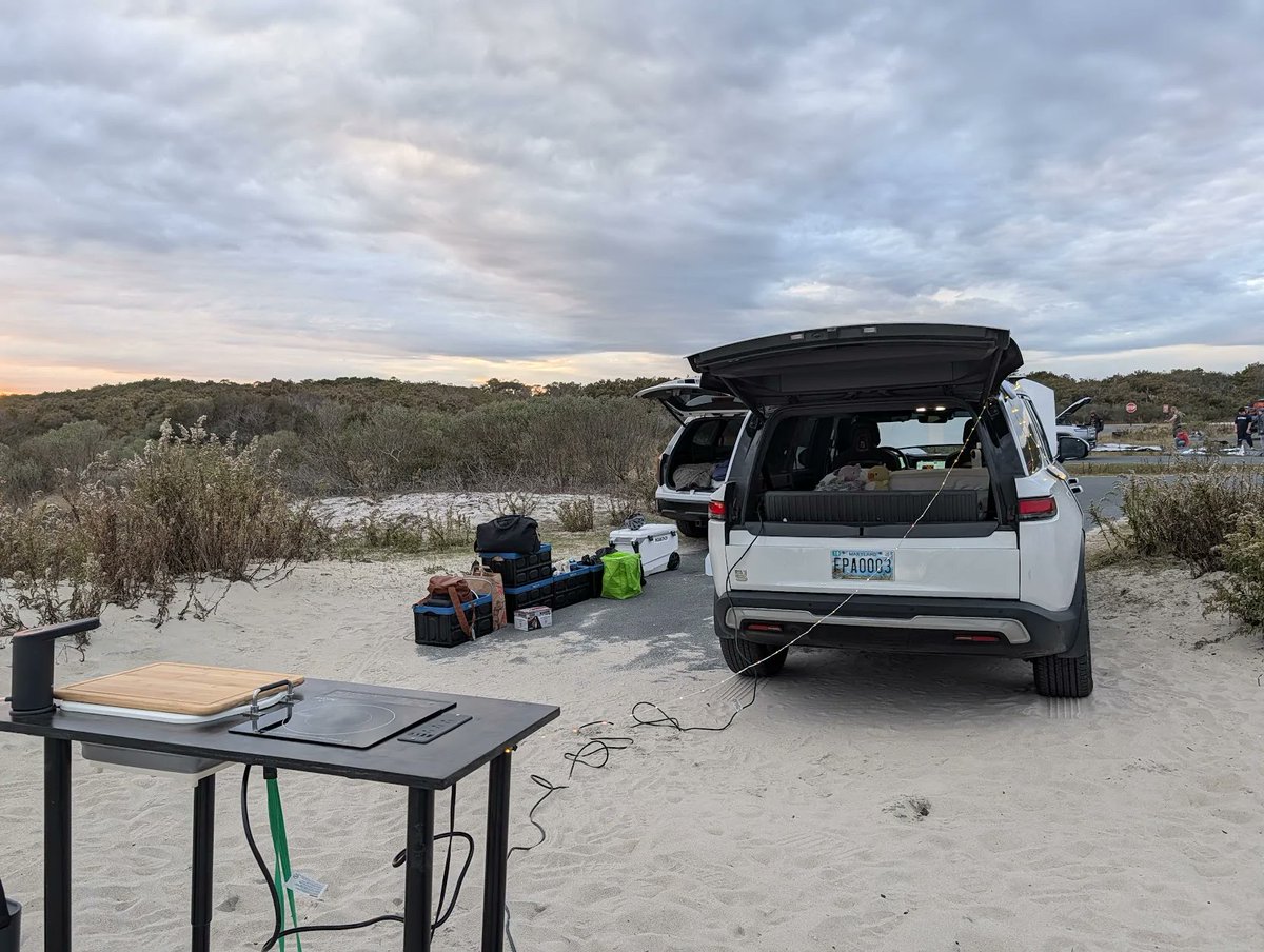 Kanundrum17's tweet photo. I got a few inquiries on my R1S Camp Kitchen that is standalone but integrate. Setup time is about 2 minutes, can easily pack up and leave during a freak storm. #Rivian #R1S #campkitchen https://t.co/cdejM6Efvx