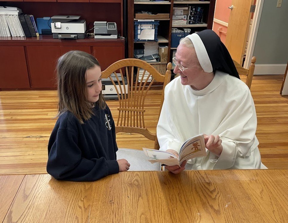 Reading Week is a time for creativity, too! One of our first-grade students read to Sister Mary Amata a book she wrote and illustrated about a bunny who takes a trip to Texas and makes friends with a bear. Firedogs are readers AND writers! 📚📝