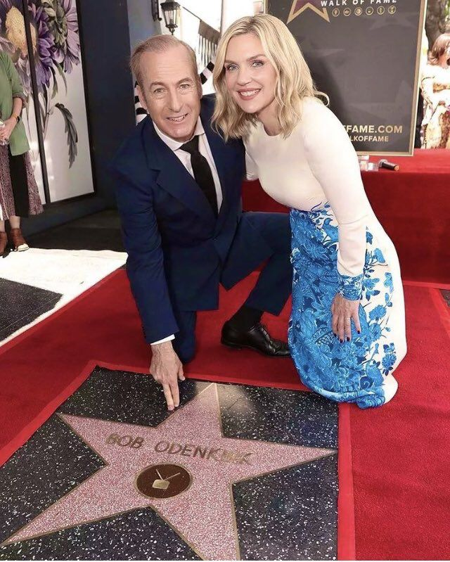 Bob Odenkirk and Rhea Seehorn posing next to Bob Odenkirk's star on the Hollywood Walk of Fame.