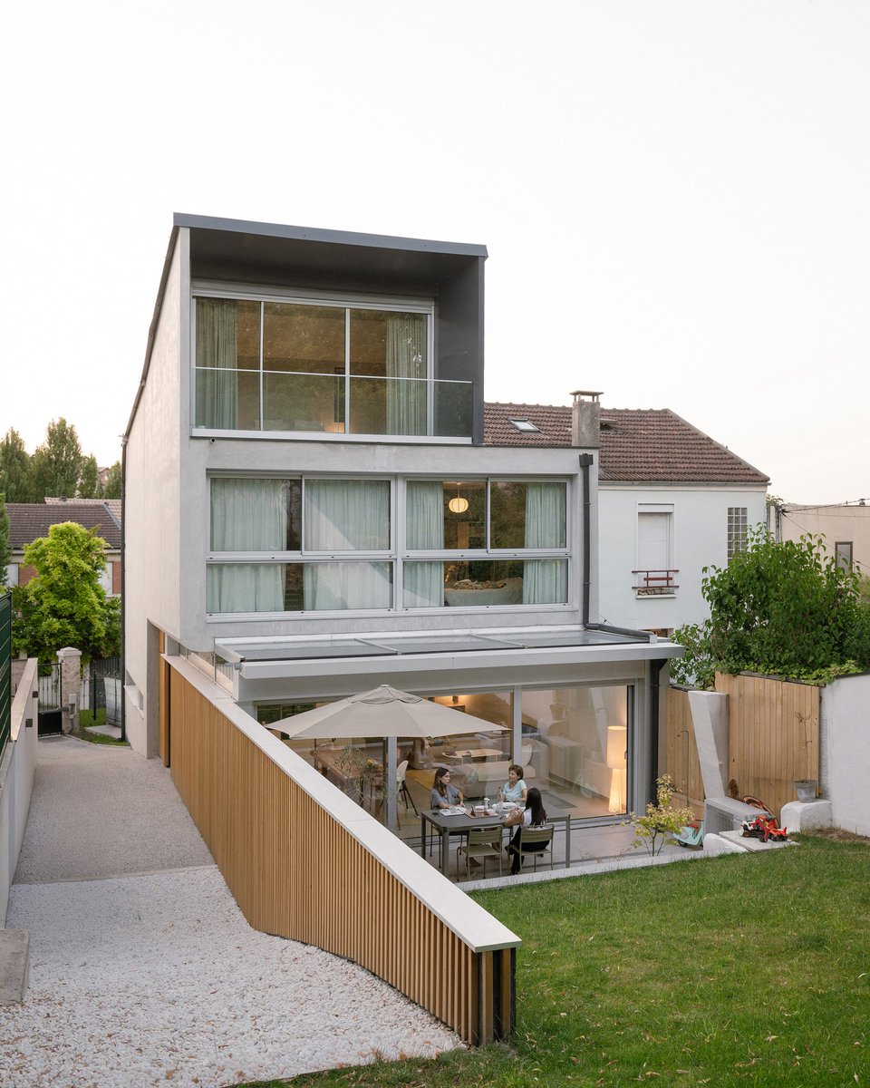 DesignedHomes's tweet photo. two homes, one building. timber louvres on the street side, full glass opening to the garden behind. 2in1 Houses in Noisy-le-Sec, Paris by MXarchitecture. https://t.co/NXaGjnu02z