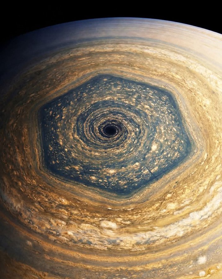 Saturn's north pole is a perfect hexagonal storm! 

Earth is about 12,700 km wide. This hexagon is nearly 30,000 km across. You could drop two whole Earths inside this storm and they still wouldn't touch the sides. A geometric masterpiece raging at the top of the world.
NASA