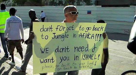 africatodayMG's tweet photo. Israel 🇮🇱 

An Israeli with a sign saying,

"Don't forget to go back to jungle in Africa. We don't need and want you in Israel! Please go back to your land! Go back to Africa!! (2016) https://t.co/cC4QNIlTmr