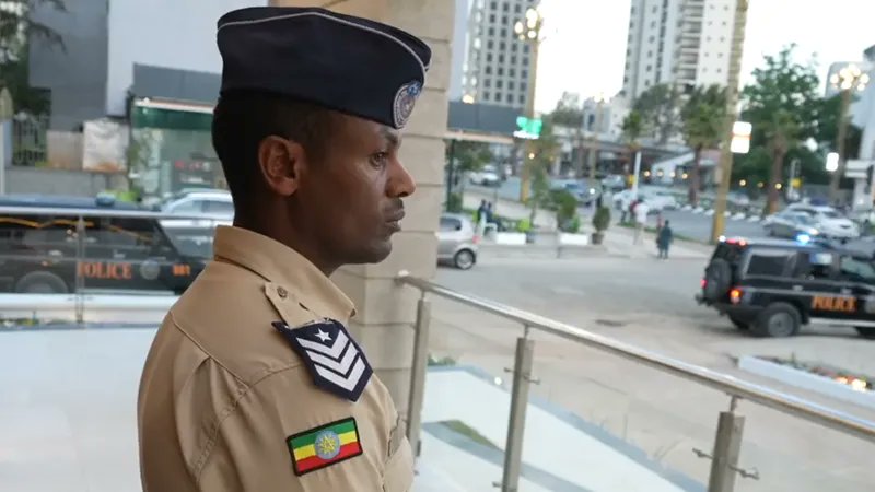 addisstandard's tweet photo. Goodbye officer, hello touchscreen - a vision for policing in #Ethiopia
Computer tablet screens glow inside a row of partitioned booths at this new-style Ethiopian #police_station. There is no commotion. There is no front desk, no bench of anxiously waiting civilians, no officer calling out names.
This pilot project of what is being called a "smart" - or unmanned - police station in the Bole district of the capital, Addis Ababa, is the latest chapter in Ethiopia's bid to catch up with the digital revolution. A large monitor on the wall cycles through welcome messages as well as images of Prime Minister #Abiy_Ahmed.
But at the moment there are uniformed officers standing by to demonstrate how the system works - it makes the place feels more like a tech showroom. Recently opened, the staff "are here to help people get used to it", the police's head of technology expansion department Cdr Demissie Yilma tells the BBC.
Inside a booth, he taps a screen and goes through the steps to make a report. Demissie selects the type of incident - a crime, a traffic report or a general concern - enters the details and presses a button to submit the comment.
Then, an officer - who is a real person in a remote location rather than a chatbot - pops up on the screen and begins to ask questions and take down information. "If there is a problem, officers respond immediately and patrol the area mentioned by the reporter," Demissie says.
In its first week last month, the smart police station (#SPS) received just three reports: a lost passport, a financial fraud case and a routine complaint. But Demissie believes the number of reports will grow as locals become more aware of it. "The future police service should be near the citizens," he says.
Ironically, the use of a computer tablet to communicate with officials may mean less human-to-human contact but the authorities believe that the SPS could increase access to the police in places where there may not be enough personnel to man a fully fledged station.
At the project's launch on 9 February, the prime minister was quoted in state media as saying that it was aimed at making "law enforcement institutions competent and competitive" and he framed it as part of a wider digital reform drive.
https://t.co/3x2n3K6Fkv